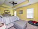 Bright bedroom with yellow walls, tray ceiling, and a comfortable bed with neutral bedding at 3009 Canopy Dr, Indian Trail, NC 28079
