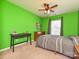 Green bedroom featuring a bed, desk, and ceiling fan at 3009 Canopy Dr, Indian Trail, NC 28079