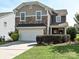 Charming two-story home featuring a stone facade, two-car garage, and well-maintained landscaping at 3009 Canopy Dr, Indian Trail, NC 28079