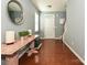 Bright foyer with hardwood floors, a decorative table, and a view of the staircase at 3009 Canopy Dr, Indian Trail, NC 28079