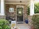 Inviting front porch with stone accents, adorned with a welcome sign and potted plants at 3009 Canopy Dr, Indian Trail, NC 28079