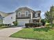 Charming two-story home features a manicured lawn, stone accents, and a two-car garage at 3009 Canopy Dr, Indian Trail, NC 28079