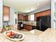 Modern kitchen with granite countertops, stainless steel appliances, and dark wood cabinetry at 3009 Canopy Dr, Indian Trail, NC 28079