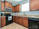 Functional kitchen with granite countertops and black appliances, ideal for cooking enthusiasts at 3009 Canopy Dr, Indian Trail, NC 28079