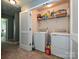Practical laundry room with washer, dryer and shelving units for storage at 3009 Canopy Dr, Indian Trail, NC 28079
