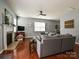 Cozy living room featuring a fireplace, large sectional sofa, and wood flooring at 3009 Canopy Dr, Indian Trail, NC 28079