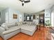 Comfortable living room featuring an oversized couch and hardwood floors at 3009 Canopy Dr, Indian Trail, NC 28079