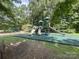 Fun-filled community playground with slides, swings, and soft landing surface, surrounded by trees at 3009 Canopy Dr, Indian Trail, NC 28079