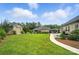 Well-manicured backyard featuring a lush lawn, detached garage, patio, and tasteful landscaping at 3256 Fairmead Dr, Concord, NC 28025