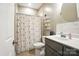 Bathroom featuring gray cabinets, white walls, decorative accents, and a shower and toilet at 3256 Fairmead Dr, Concord, NC 28025
