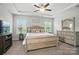 Primary bedroom featuring lots of natural light from the dual windows, as well as a console and large dresser at 3256 Fairmead Dr, Concord, NC 28025