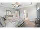 This is a primary bedroom featuring tray ceilings, neutral walls, a ceiling fan, and ensuite bathroom at 3256 Fairmead Dr, Concord, NC 28025