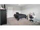 Bedroom featuring a bed, desk area, and black decor, as well as neutral walls and carpet flooring at 3256 Fairmead Dr, Concord, NC 28025
