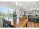 Well lit dining area with modern table, chairs, view to the kitchen, and natural light at 3256 Fairmead Dr, Concord, NC 28025