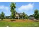 A well-maintained front yard, a brick facade, and dormer windows highlight this home at 3256 Fairmead Dr, Concord, NC 28025