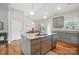 Open kitchen features a large island with granite countertops and stainless steel appliances at 3256 Fairmead Dr, Concord, NC 28025