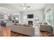 Open-concept living room with hardwood floors, fireplace, and view of the kitchen at 3256 Fairmead Dr, Concord, NC 28025