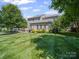 The backyard of this home features a meticulously maintained lawn and lovely, mature landscaping at 3301 Old Knobbley Oak Dr, Gastonia, NC 28056