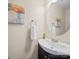 A half bath featuring modern fixtures, neutral walls, and a large mirror at 3301 Old Knobbley Oak Dr, Gastonia, NC 28056