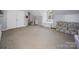 Secondary bedroom featuring carpeted floor and light gray walls with a large window and natural lighting at 3301 Old Knobbley Oak Dr, Gastonia, NC 28056