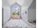 Bright bedroom showcasing large arched windows and neutral-toned walls with floral patterned bedding at 3301 Old Knobbley Oak Dr, Gastonia, NC 28056