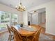 Bright dining room with a wooden table set with a light blue runner and centerpiece at 3301 Old Knobbley Oak Dr, Gastonia, NC 28056
