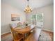 Bright dining room featuring a wooden table, matching chairs and bench, and ample natural light at 3301 Old Knobbley Oak Dr, Gastonia, NC 28056