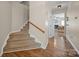 Hallway view with staircase to the upper level, and access to the living area and bedrooms at 3301 Old Knobbley Oak Dr, Gastonia, NC 28056