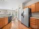 Galley style kitchen with a stainless steel refrigerator and breakfast area with backyard views at 3301 Old Knobbley Oak Dr, Gastonia, NC 28056