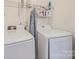 Bright laundry room area with washer, dryer, and shelving for all your laundry needs at 3301 Old Knobbley Oak Dr, Gastonia, NC 28056
