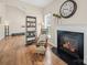 Cozy living room with a fireplace, wooden floors, and comfortable seating at 3301 Old Knobbley Oak Dr, Gastonia, NC 28056