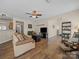 Spacious living room with hardwood floors and a ceiling fan at 3301 Old Knobbley Oak Dr, Gastonia, NC 28056