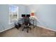 A home office features lots of light, neutral walls, and plenty of space at 3301 Old Knobbley Oak Dr, Gastonia, NC 28056