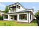 Beautiful backyard featuring a covered patio, well manicured lawn, and modern architectural details at 3308 Carmel Rd, Charlotte, NC 28226
