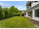 Lush backyard featuring a well-maintained lawn, landscaping, and a stylish modern home at 3308 Carmel Rd, Charlotte, NC 28226