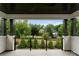 Covered balcony with views of the surrounding trees and landscaped yard at 3308 Carmel Rd, Charlotte, NC 28226