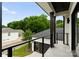 Open-air balcony with black iron railings overlooking lush greenery and a driveway at 3308 Carmel Rd, Charlotte, NC 28226