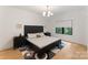 Bright bedroom with wood floors, neutral decor, and a view of the outdoors at 3308 Carmel Rd, Charlotte, NC 28226