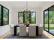 Dining room featuring modern light fixture, a large window, and sliding glass door at 3308 Carmel Rd, Charlotte, NC 28226