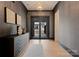 Beautiful foyer features hardwood floors, gray textured walls, and a stylish console table with decorative items at 3308 Carmel Rd, Charlotte, NC 28226