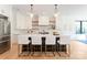 Charming kitchen features white cabinets, a large island, modern pendant lighting, and stainless steel appliances at 3308 Carmel Rd, Charlotte, NC 28226