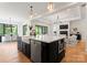 Open concept kitchen with a large island, stainless steel appliances, and views into the dining and living areas at 3308 Carmel Rd, Charlotte, NC 28226