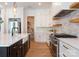 Bright kitchen showcases white cabinets, a center island, stainless steel appliances, and open shelving at 3308 Carmel Rd, Charlotte, NC 28226