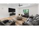 Well-lit living room featuring comfortable seating, a large screen, and contemporary decor at 3308 Carmel Rd, Charlotte, NC 28226