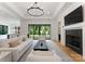 Bright living room with a fireplace, chandelier, and view of backyard at 3308 Carmel Rd, Charlotte, NC 28226
