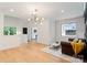 Bright living room featuring wood floors, stylish lighting, and an adjacent entryway at 3308 Carmel Rd, Charlotte, NC 28226