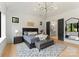 Bright main bedroom featuring high ceilings, modern chandelier, and ensuite bathroom access at 3308 Carmel Rd, Charlotte, NC 28226