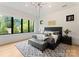 Primary bedroom features large windows, tray ceiling, neutral decor, and hardwood floors at 3308 Carmel Rd, Charlotte, NC 28226