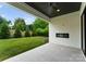 Inviting outdoor patio with a fireplace, overlooking a well-manicured lawn and lush landscaping at 3308 Carmel Rd, Charlotte, NC 28226