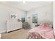 Charming bedroom with a white iron bed frame, large windows, and dresser with decorative accents at 3332 Katherine Taylor Ct, Monroe, NC 28110